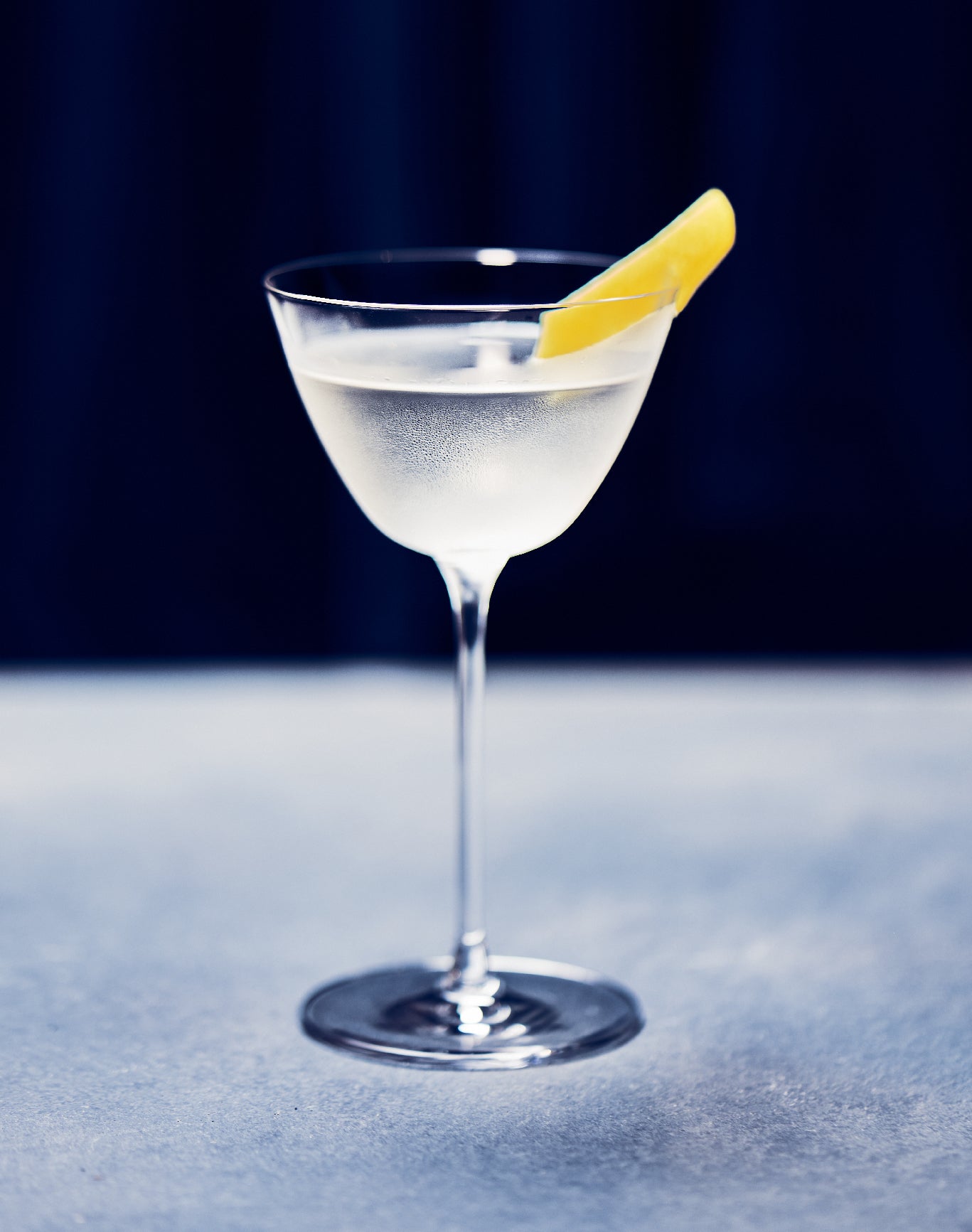 A photo of a Botanisrt cocktail on a blue background