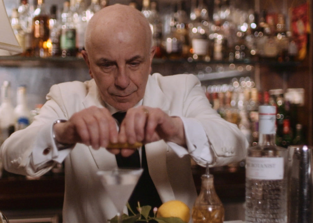 A photo of a bartender preparing a Botanist cocktail