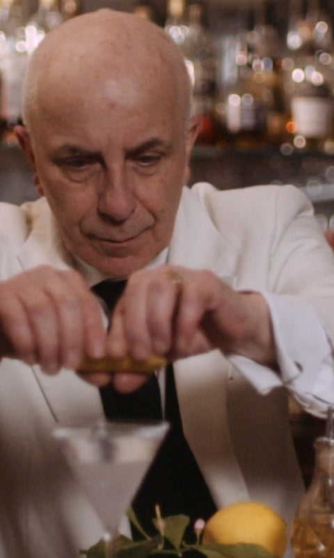 A photo of a bartender preparing a Botanist cocktail
