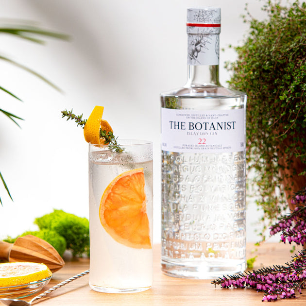 A lifestyle photo of a Botanist bottle close to a cocktail glass with Cotrus Breeze